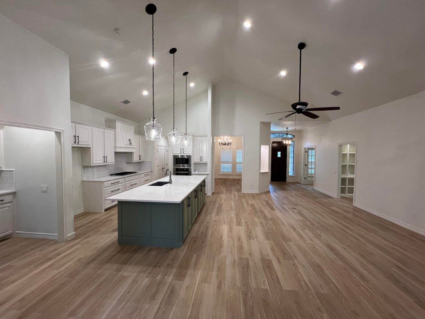 Kitchen remodel with white cabinets, marble countertops and teal island in Fort Worth